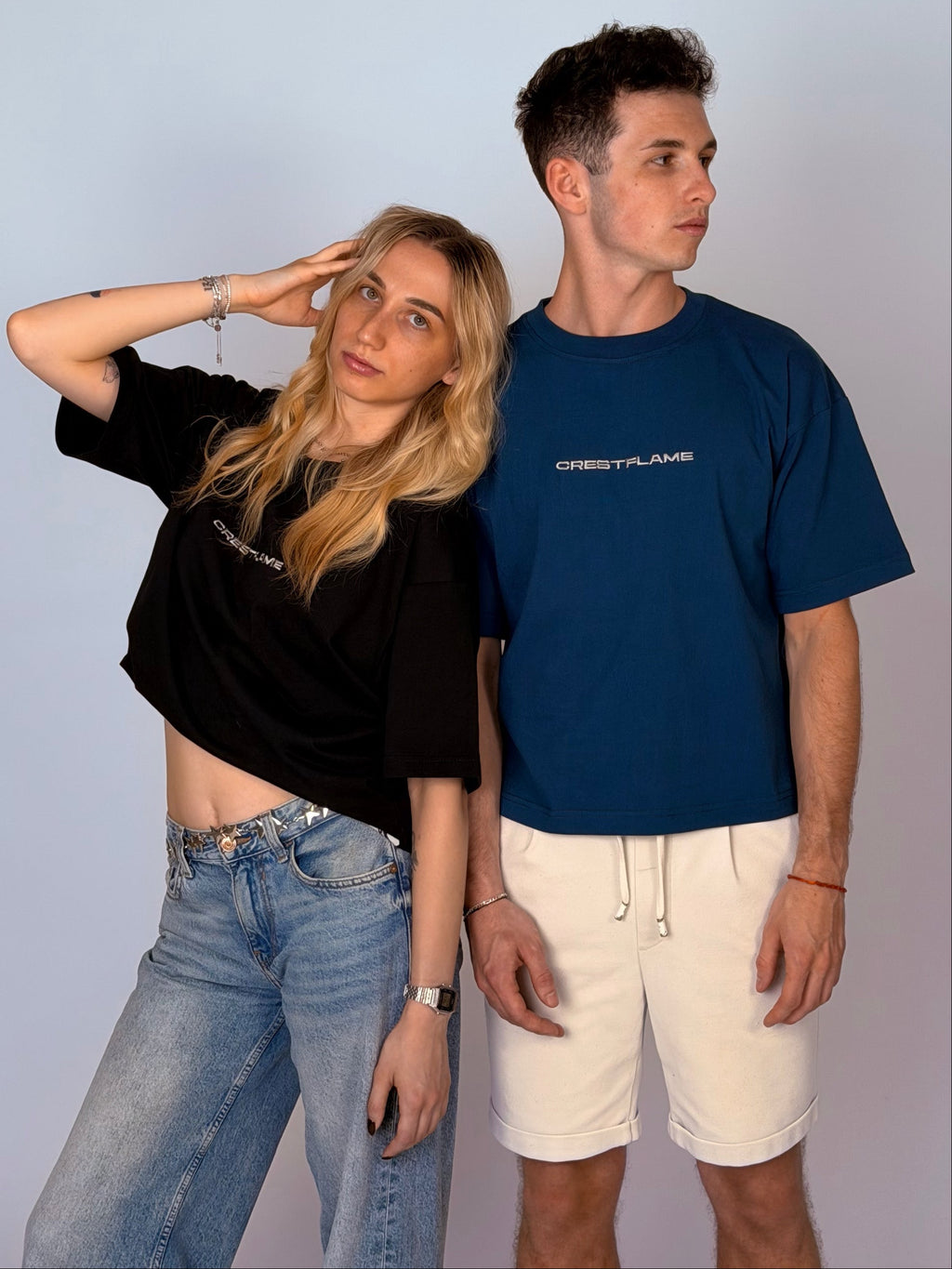 Two people standing side by side against a plain background